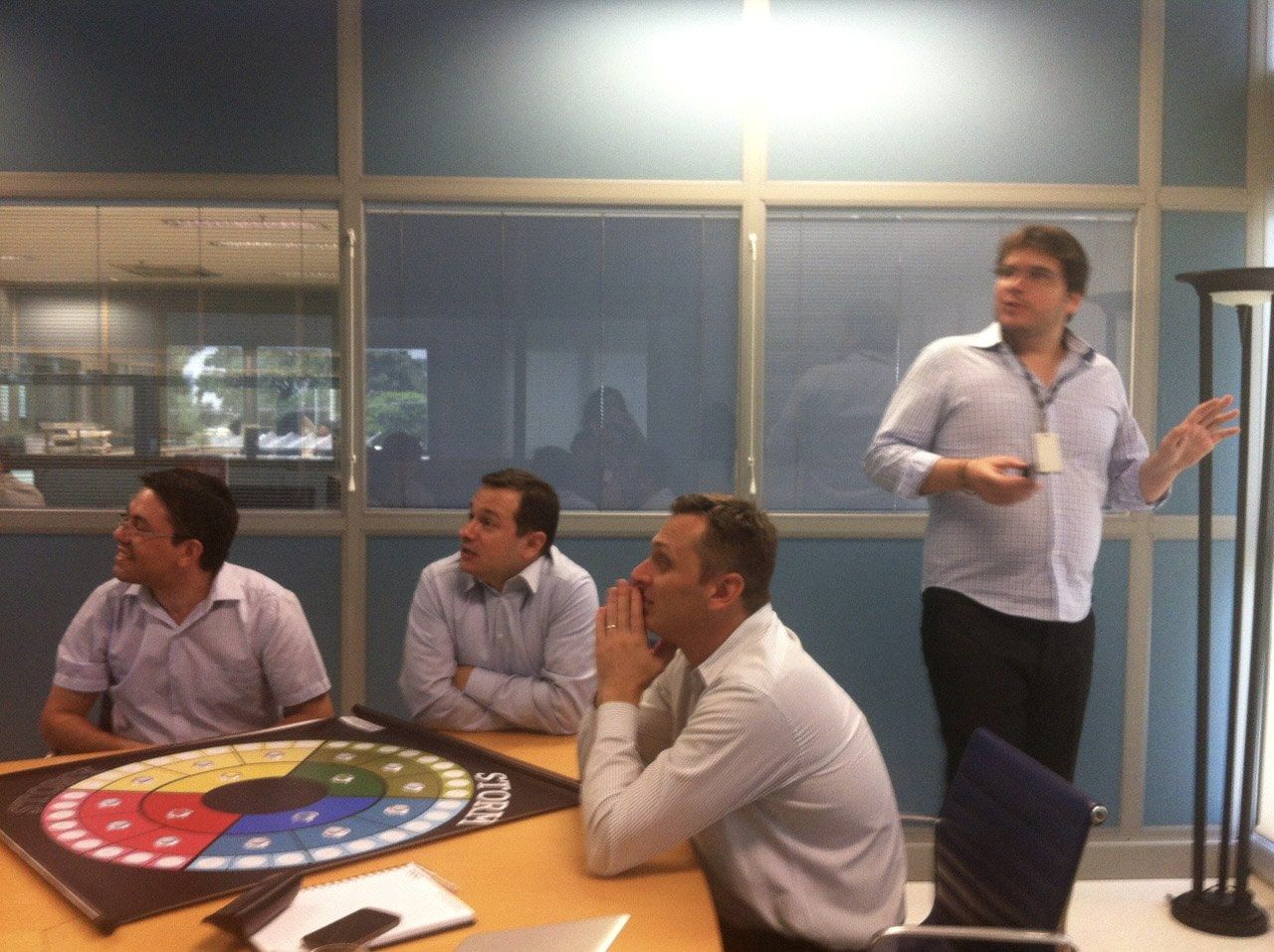 Fernando Palacios running a storytelling session with a corporate team seated around a boardroom table