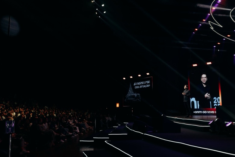 Audience in a darkened auditorium during a keynote