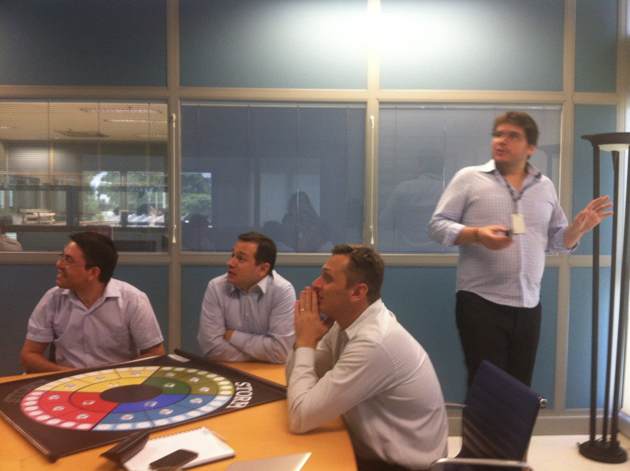 Fernando Palacios running a storytelling session with a corporate team seated around a boardroom table